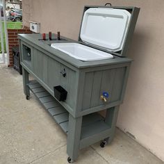 a cooler sitting on top of a sidewalk next to a building