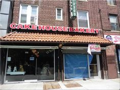 a large brick building with a sign that says cake house bakery on it's front