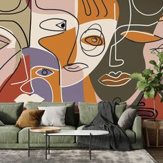 a living room scene with focus on the couch and wallpaper that has colorful faces