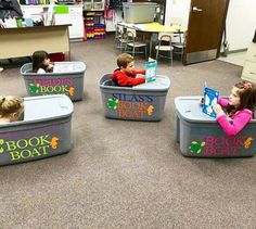 children reading books in plastic containers on the floor