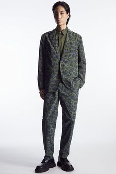 Classic and contemporary tailoring codes come together in this blazer from the Autumn Winter menswear collection. Expertly tailored on our regular-fit block, it's crafted from recycled fabric that's jacquard-woven with a refined take on animal print and has an angled chest welt pocket, flapped front pockets and a back vent to prevent creasing as you sit. Embrace a maximalist sensibility by styling it with the coordinating trousers. Regular fitMother-of-pearl buttonsA better alternative to conventional polyester, recycled polyester is made from pre‐ and post‐consumer waste Shell & Lining: 100% Recycled polyester / Machine wash Back length of size EU 48 is 73.25cm / Model wears a size EU 48 Jacquard Blazer With Notch Lapel For Work, Tailored Jacquard Suits, Fall Jacquard Blazer For Workwear, Tailored Jacquard Suits With Long Sleeve, Tailored Jacquard Single Breasted Blazer, Tailored Single Breasted Jacquard Blazer, Tailored Jacquard Single-breasted Blazer, Tailored Jacquard Blazer For Semi-formal Occasions, Long Sleeve Jacquard Blazer For Work