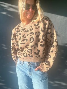 Get cozy while making a statement with our Can You Feel It sweater. This chic brown knit features a playful black leopard print and relaxed, cropped fit. The long sleeves are perfect for cooler weather and it pairs perfectly with high-waisted bottoms. You'll be the trendiest one around! Trendy Leopard Print Winter Sweater, Winter Leopard Print Crew Neck Sweater, Trendy Cropped Brown Sweater, Trendy Leopard Print Crew Neck Sweater, Oversized Casual Leopard Print Sweater, Trendy Brown Cropped Sweater For Fall, Trendy Relaxed Fit Cropped Sweater For Fall, Free People Swim, Leopard Print Sweater