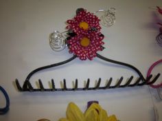 a hair comb with a flower on top of it next to scissors and other items