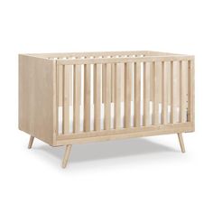 a small wooden crib with white sheets