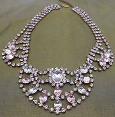 Dazzling vintage statement costume festoon necklace with pink paste fx gems and endless diamantes. Timeless elegant design with show-stopping sparkle.  1940s/50s glamour piece ... as beautiful today as it was ... and will be for many moons to come Excellent vintage condition Length: Adjustable 41.5 - 46 cm / 16.2 - 18 inch Drop: 5.7 cm / 2.2 inch ☞ Please view my shipping and sales policies & ✎ Contact me with questions prior to purchase...all sales are final:  http://www.etsy.com/shop/Andeebird/policy Pink Crystal Rhinestone Necklace In Glamorous Style, Pink Rhinestone Jeweled Necklace For Parties, Elegant Pink Rhinestone Necklace With Sparkling Stones, Glamorous Pink Rhinestone Necklace For Party, Glamorous Pink Rhinestone Necklace, Pink Rhinestone Necklace For Party, Glamorous Pink Evening Necklaces, Elegant Pink Rhinestone Necklace For Party, Pink Crystal Rhinestone Necklace For Wedding