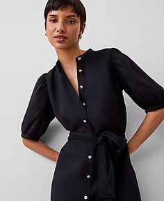 Elevate your wardrobe with the Ann Taylor Stand Collar Belted Midi Shirtdress, a piece that marries sophistication with comfort. This elegant black dress features a distinctive stand collar and puff sleeves with shirred caps, adding a touch of refinement to your look.

- Size: 6 (Regular fit)
- Color: Black
- Material: 100% Polyester
- Gender: Female
- Features: Stand collar, short sleeves, button front placket, self-tie belt, lined body
- Length: Hits at mid-calf, 30" from natural waist
- Care Black Puff Sleeve Office Dress, Spring Workwear Midi Dress With Stand Collar, Chic Stand Collar Midi Dress For Work, Chic Long Sleeve Puff Sleeve Dress For Office, Fitted Midi Dress With Stand Collar For Work, Chic Midi Dress With Stand Collar For Work, Chic Midi Dress With Blouson Sleeves For Daywear, Chic Puff Sleeve Dress With Blouson Sleeves For Work, Elegant Summer Midi Dress With Blouson Sleeves