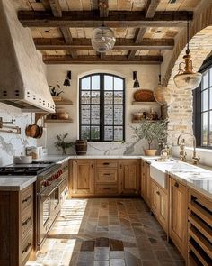 a kitchen filled with lots of wooden cabinets and counter top space next to a window