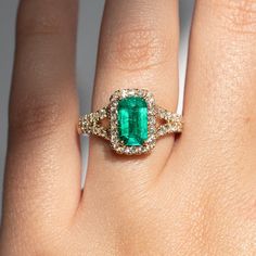 A vibrant emerald wrapped in a lovely diamond bodice. Materials: 18k yellow gold, Columbian Emerald, Diamond Weights: 1.15ct Emerald, 0.76ct Diamond Size: 6.5 Green Emerald Diamond Ring With Pave Setting, Gold Emerald Ring With Pave Setting, Green Emerald Ring With Pave Setting, Gold Emerald Ring With Pavé Setting, Gold Emerald Cut Ring With Pave Setting, Green Emerald Ring With Pave Setting For May Birthstone, May Birthstone Emerald Ring With Pave Setting, Emerald Pave Setting Ring For Anniversary, Gia Certified Dazzling Green Diamond Ring