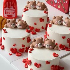 there are four cakes decorated with teddy bears on the top one is white and the other has red hearts