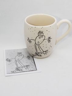 a coffee cup with a drawing on it