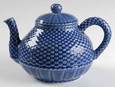 a blue and white checkered teapot with a lid on the side, sitting in front of a white background