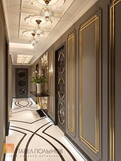 an elegant hallway with gold trimming and chandeliers