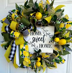 a wreath that says home sweet and has lemons on the front, with ribbons around it