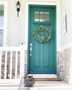 a green front door with a wreath on it