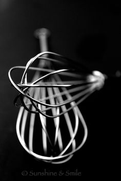 a black and white photo of a whisk