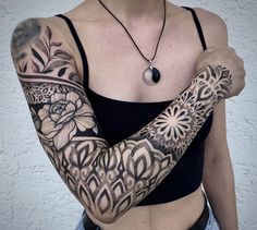 a woman with tattoos on her arms and chest