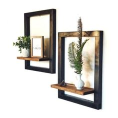 three wooden shelves with plants and pictures on them