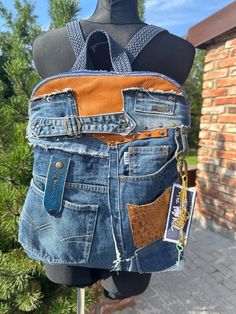 an old pair of jeans is being displayed on a mannequin's head