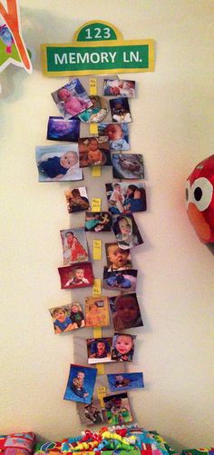 a wall with pictures and magnets on it next to a stuffed toy fish in the corner