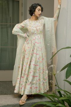 Mint green flared blossom anarkali with an embroidered body yoke. Paired with a silk organza dupatta with scalloped edges.
Components: 2
Pattern: Print, Embroidery
Type Of Work: Floral, Birds
Neckline: Round Neck
Sleeve Type: Full Churidar Sleeves
Fabric: Anarkali: Printed Tussar, Dupion Silk
Dupatta : Silk Organza 
Color: Green
Other Details: 
Attached lining
Model height: 5 ft 7 inches, wearing size S
Length from shoulder(in inches): 58
Closure: Side zipper
Note:
Anarkali does not come with pa Transitional Season Fitted Mulmul Anarkali Set, Designer Chanderi Maxi Sets, Fitted Mulmul Anarkali Set For Navratri, Transitional Maxi Length Sets With Sheer Dupatta, Anarkali Sets With Cutdana In Maxi Length, Bollywood Style Floor-length Cotton Silk Sets, Pista Green Semi-stitched Lehenga With Straight Kurta, Fitted Mulmul Anarkali Set With Straight Kurta, Pista Green Mulmul Anarkali Set With Dabka Work