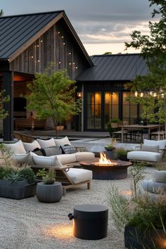 an outdoor living area with couches, tables and fire pit in the foreground