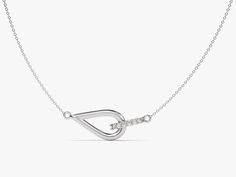 a silver necklace with a diamond on the bottom and an arrow in the middle, hanging from