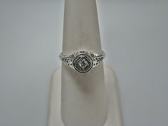 "For Sale: (1) H108 Gorgeous Diamond Ring in 14k White Gold from 1930's PLEASE READ ENTIRE DESCRIPTION BEFORE PURCHASING Please see pictures for more details! This stunning ring features a center 0.06 ct diamond. This is a beautiful filigree mounting down the side. The shank is decorated half way down. The ring is not stamped 14k, but was tested for it. This ring is from the 1930's. A beautiful piece for a any special occasion! What a great Gift! Specifics: *14k White Gold *Center Diamond approx Vintage White Gold Signet Ring With Center Stone, Classic Diamond Signet Ring Collectible, Classic White Gold Signet Ring Collectible, Collectible Classic Diamond Signet Ring, Antique White Gold Diamond Ring Stamped 14k, Antique Signet Ring For Anniversary With Round Band, Collectible Heirloom Solitaire Ring, Antique 14k White Gold Diamond Ring Hallmarked, Heirloom Diamond White Signet Ring For Formal Occasions