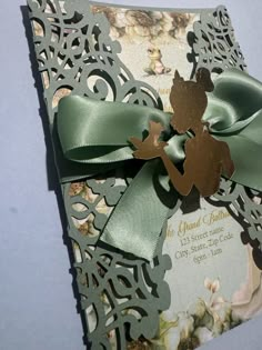 a close up of a card with a green bow on it's front and back