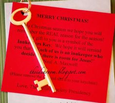 a christmas card with a key hanging from it's end on top of a piece of paper