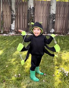 a little boy dressed up in a costume