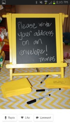 a blackboard with writing on it sitting on top of a table