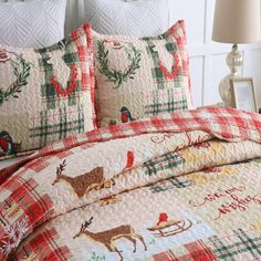 the comforter is made up and has reindeers on it, with christmas decorations