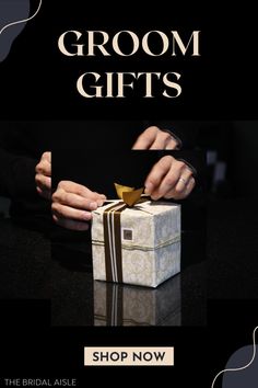 a person opening a gift box with the words groom gifts shop now on top of it