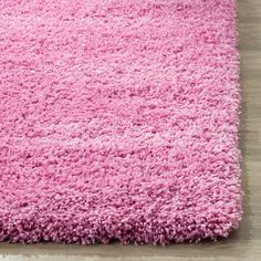 a pink rug on top of a wooden floor