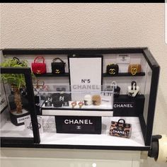 a display case containing chanel purses and handbags