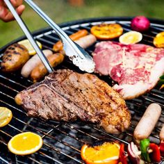 a person is grilling meat and vegetables on a bbq