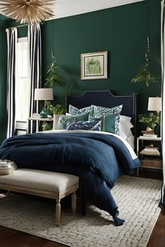 a bedroom with green walls and blue bedding in the center, along with white curtains