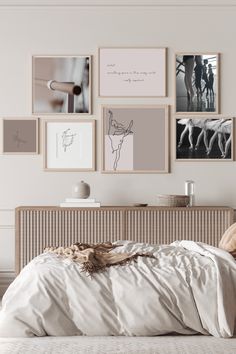 a bed with white sheets and pictures on the wall above it, along with pillows