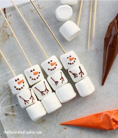 marshmallows are arranged in the shape of a snowman on a stick