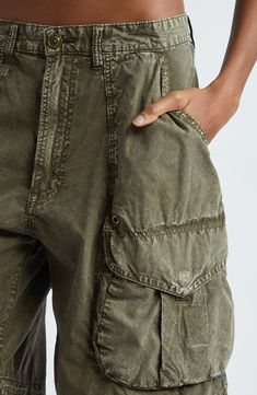 Chris Leba's rebellious vision shines through the baggy silhouette and artfully faded edges of all-cotton cargo shorts designed to be slung low on the hips. Zip fly with button closure Front slant pockets; back button-flap pockets; cargo bellows pockets 100% cotton Machine wash, line dry Imported Designer Clothing Cotton Combat Cargo Shorts, Functional Cotton Cargo Shorts, Military Style Cotton Cargo Shorts With Belt Loops, Military Style Cargo Shorts With Multiple Pockets, Mens Designer Jeans, Military Cargo Cotton Shorts, Designer Shorts, Designer Jeans, Cargo Shorts