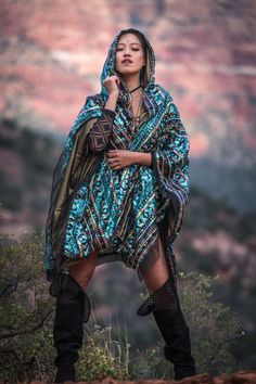 A stunning tribal sequin cape/poncho that can be worn as a unique festival outfit or as part as a transformational ceremony experience. The lightweight fabric flows in the wind and swirls around you as you dance, creating a sparkling, eye-catching effect.  ⬖ Luxurious iridescent turquoise, gold, white, and black tribal sequin print⬖ Lined with lightweight black mesh ⬖ Can be worn during hot weather or layered over a jacket during cold weather⬖ Unisex⬖ One size fits all Designed to encourage tran Hippie Shawl Poncho For Festivals, Bohemian Festival Kaftan With Sequins, Bohemian Sequin Kaftan For Festivals, Multicolor Cape For Festival, Bohemian Shawl Kaftan For Festival, Bohemian Blue Poncho For Festival, Bohemian Poncho For Festivals, Jamestown Ny, Sequin Cape