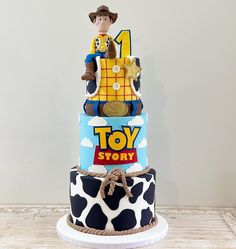 a three tiered cake decorated with toy story characters