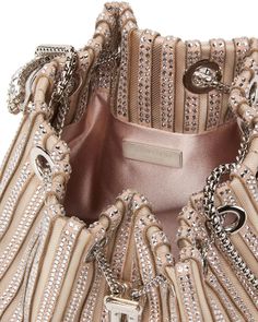 Jimmy Choo Bon Bon Crystal-Embellished Bag in Macaron Open top with chain drawstring closure Circular top handle wit crystal embellishment Gold tone hardware Satin/hotfix crystals Lined 5.5’’ W X 5.9’’ H X 7.5’’ D Made in Italy Luxury Chic Bags With Crystal Embellishments, Luxury Top Handle Bag With Chain, Luxury Bag With Detachable Strap And Round Handle, Luxury Formal Box Bag With Round Handle, Luxury Gold Ceremonial Bag, Luxury Bucket Shoulder Bag With Pearl Handle, Luxury Elegant Bags With Stone Embellishments, Luxury Top Handle Evening Bag With Chain Strap, Luxury Embellished Shoulder Bag For Travel