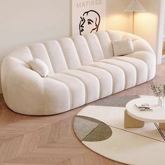 a white couch sitting on top of a hard wood floor