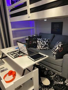 a living room with a couch, table and laptop on it