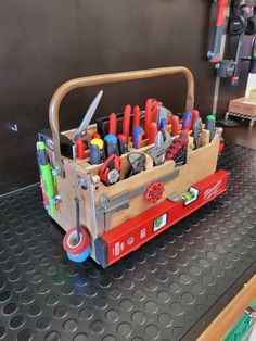 a toolbox filled with lots of tools on top of a table