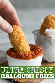 a person dipping some food into a small cup with the words extra crispy halloumi fries on it