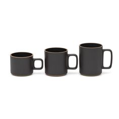 three black coffee mugs sitting next to each other