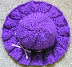 a purple knitted hat sitting on the floor