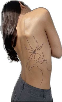 a woman's back with a tattoo on it